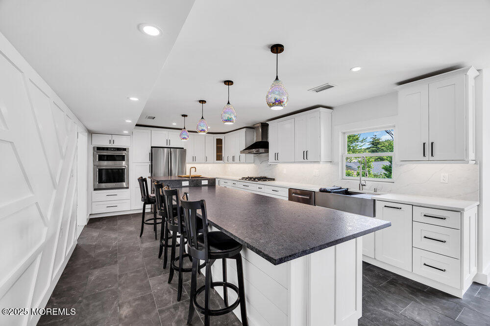 590 Lloyd Road Aberdeen, NJ 07747 - Photo 46 of 71 an open kitchen with a table and chairs in it