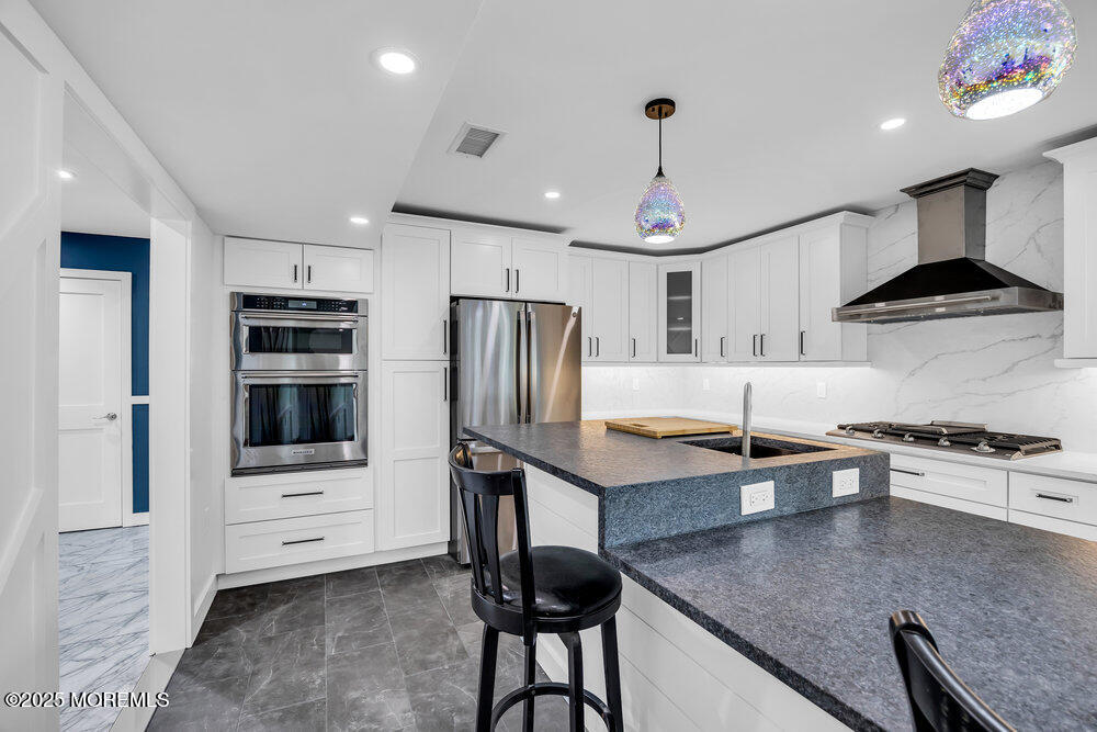 590 Lloyd Road Aberdeen, NJ 07747 - Photo 50 of 71 a kitchen with stainless steel appliances granite countertop a stove refrigerator and a sink