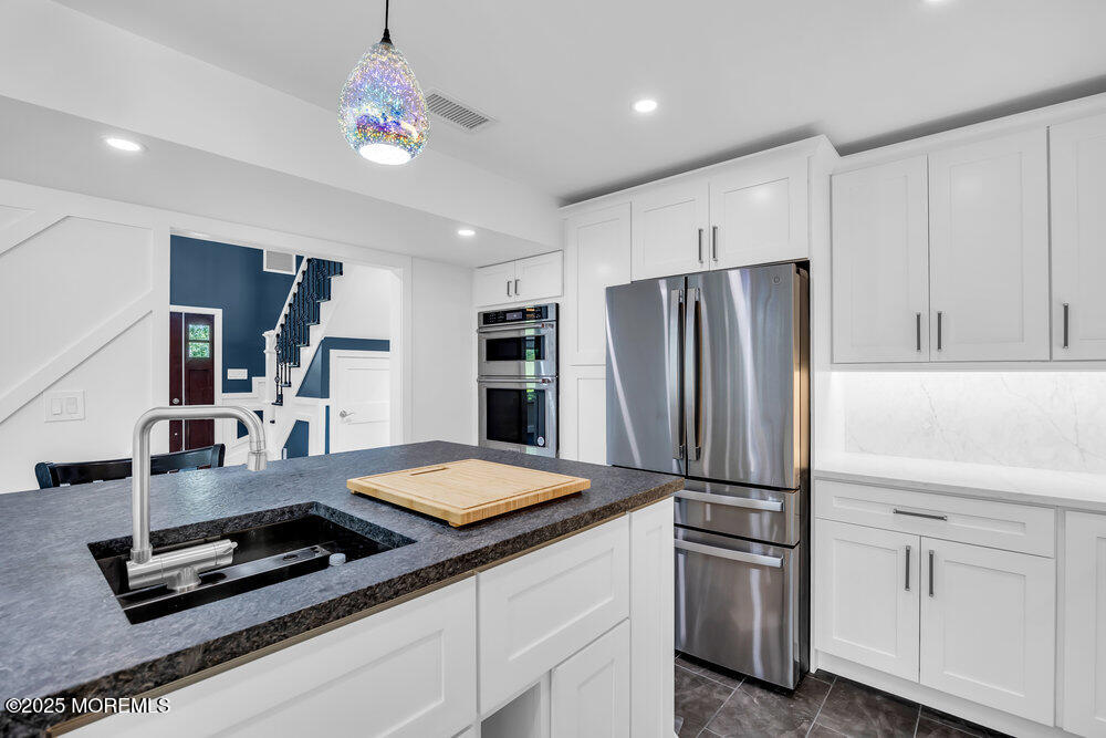 590 Lloyd Road Aberdeen, NJ 07747 - Photo 53 of 71 a kitchen with kitchen island a counter top space appliances and cabinets