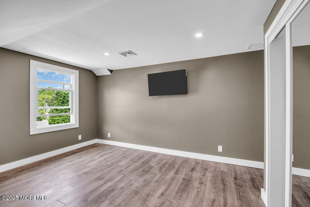 590 Lloyd Road Aberdeen, NJ 07747 - Photo 59 of 71 an empty room with wooden floor and windows