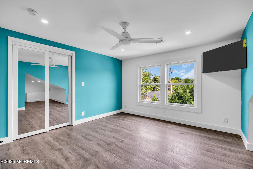 590 Lloyd Road Aberdeen, NJ 07747 - Photo 65 of 71 an empty room with wooden floor cabinet and windows