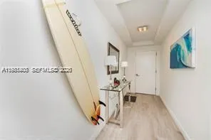 a view of a livingroom with wooden floor and stairs