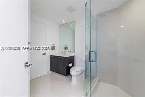 a bathroom with a toilet sink and shower
