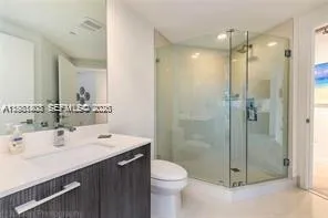 a bathroom with a sink mirror toilet and shower