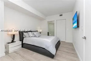 a bedroom with bed and window