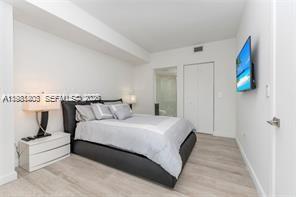 45 Southwest 9th Street, Unit 1701 Miami, FL 33130 - Photo 19 of 24 a bedroom with bed and window