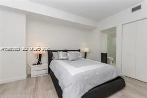 a bedroom with bed and a night stand