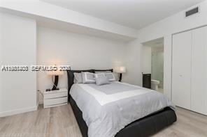 45 Southwest 9th Street, Unit 1701 Miami, FL 33130 - Photo 20 of 24 a bedroom with bed and a night stand