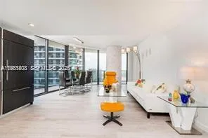 a living room with furniture a flat screen tv and a table