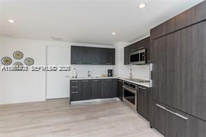 45 Southwest 9th Street, Unit 1701 Miami, FL 33130 - Photo 8 of 24 a large kitchen with a stove top oven and sink
