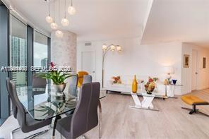 45 Southwest 9th Street, Unit 1701 Miami, FL 33130 - Photo 9 of 24 a living room with furniture flowerpot and a chandelier