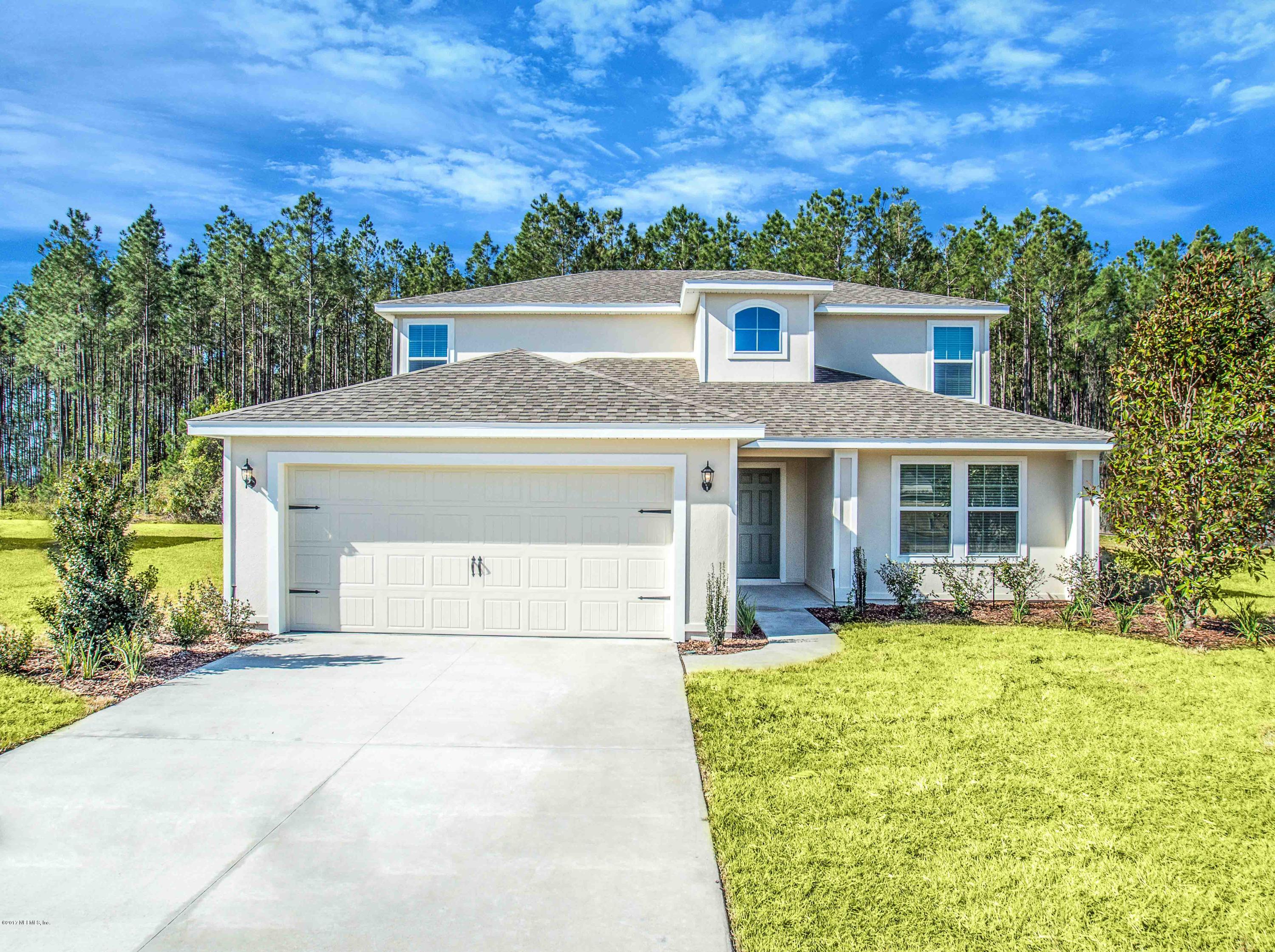 78263 Saddle Rock Road Yulee, FL 32097 - Photo 1 of 13 front view of a house with a yard