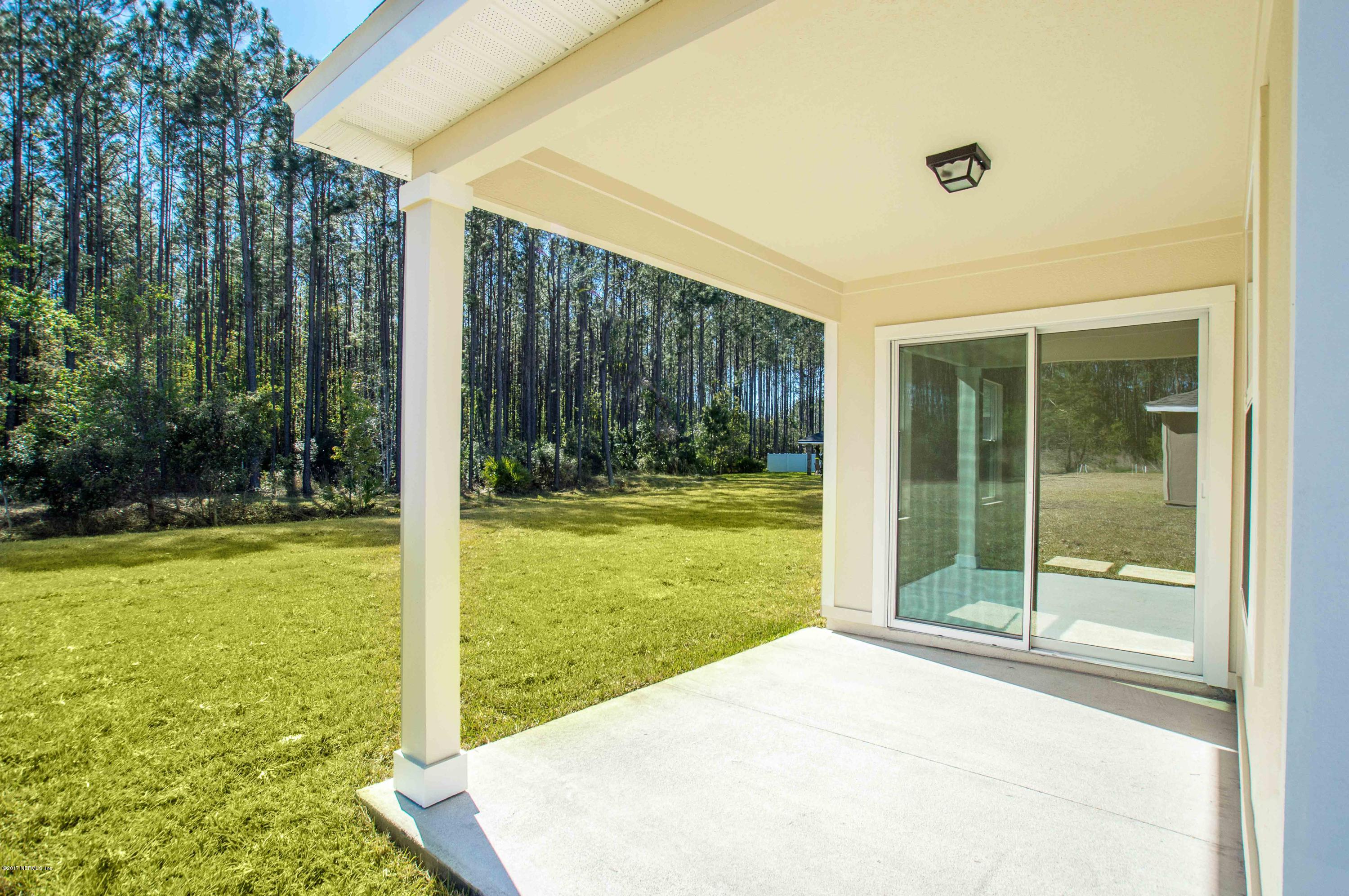 78263 Saddle Rock Road Yulee, FL 32097 - Photo 13 of 13 a view of a backyard with garden