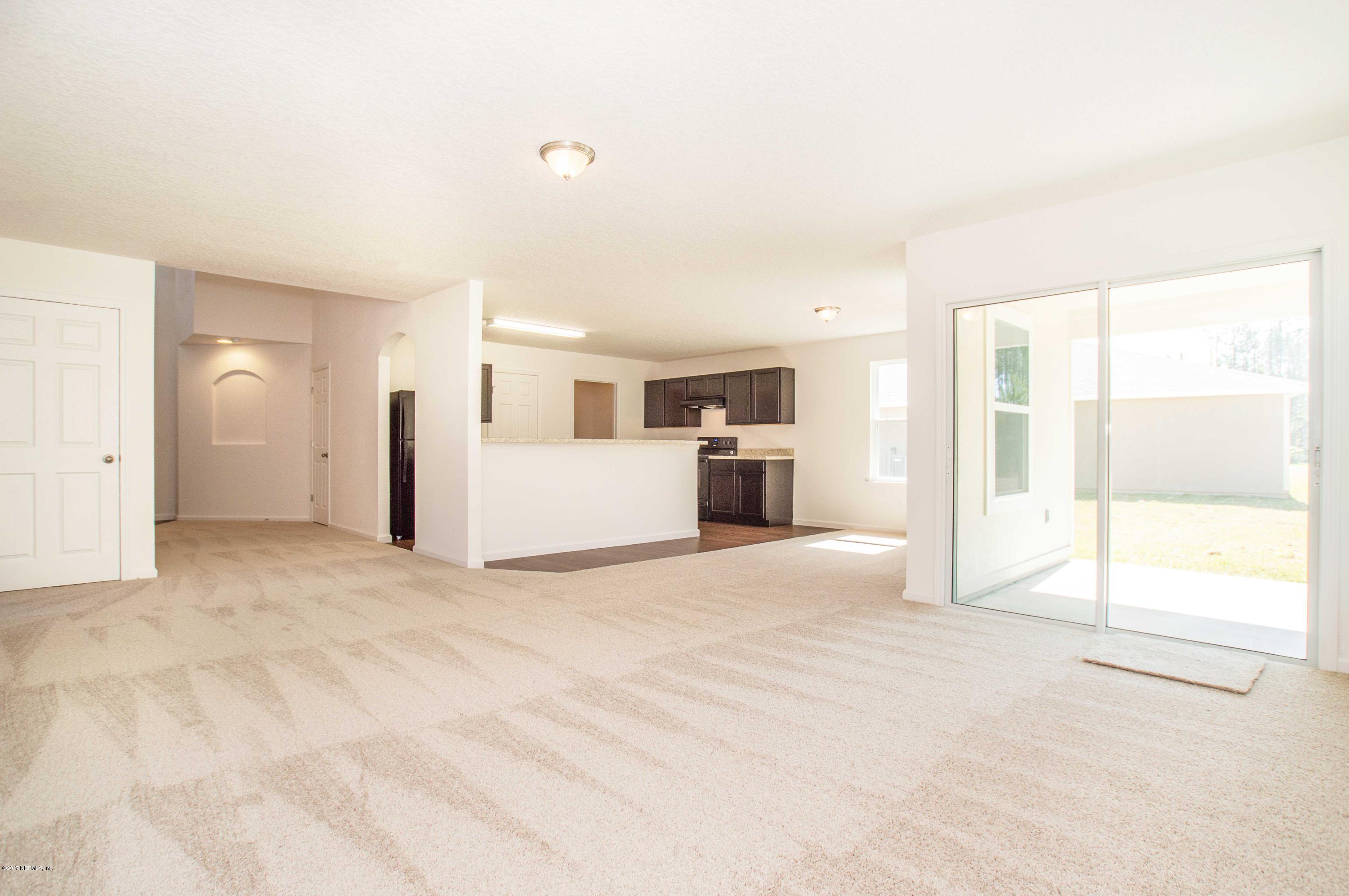 78263 Saddle Rock Road Yulee, FL 32097 - Photo 3 of 13 a view of an empty room with a window
