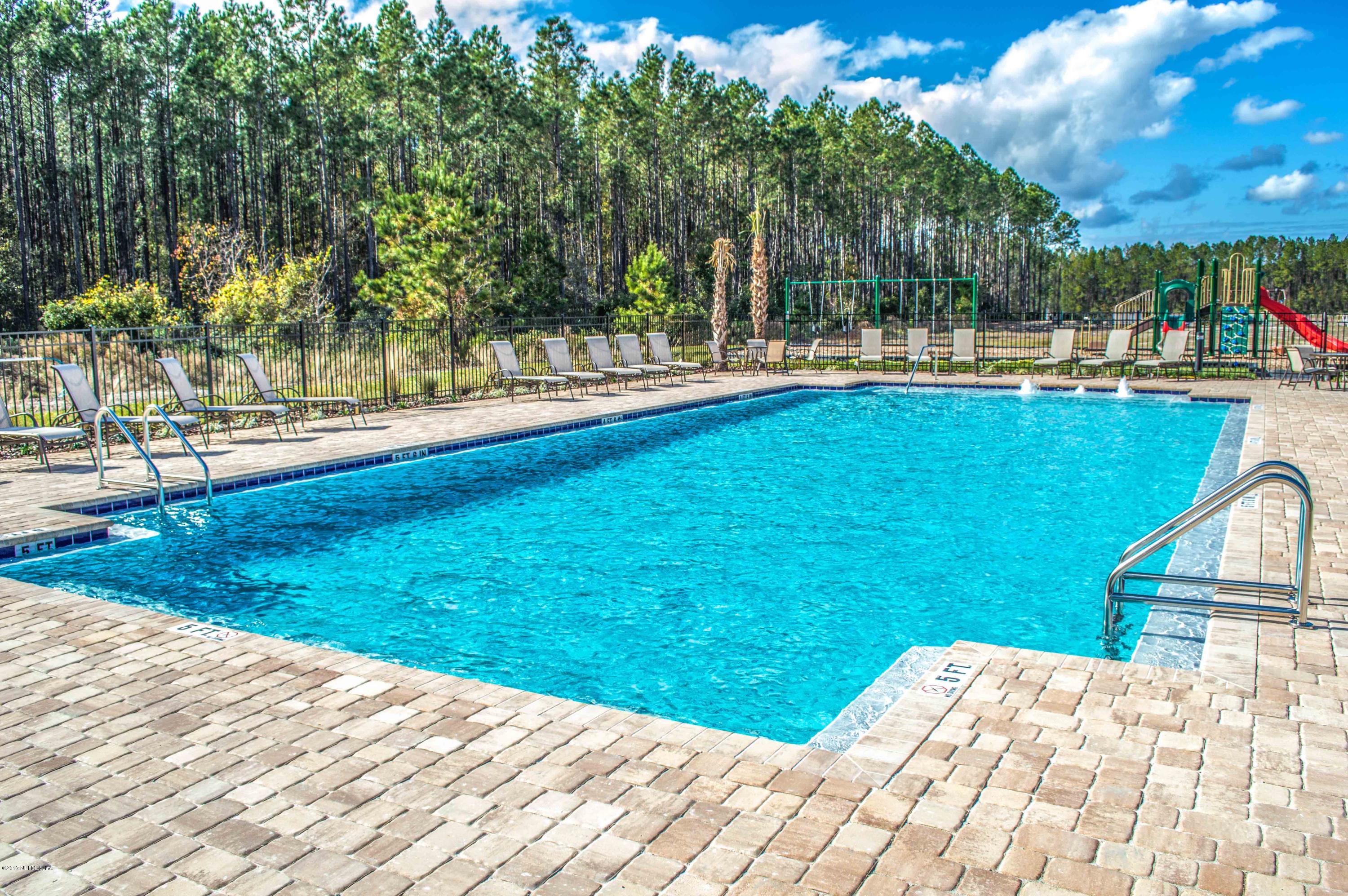 78263 Saddle Rock Road Yulee, FL 32097 - Photo 5 of 13 a view of a swimming pool with a patio