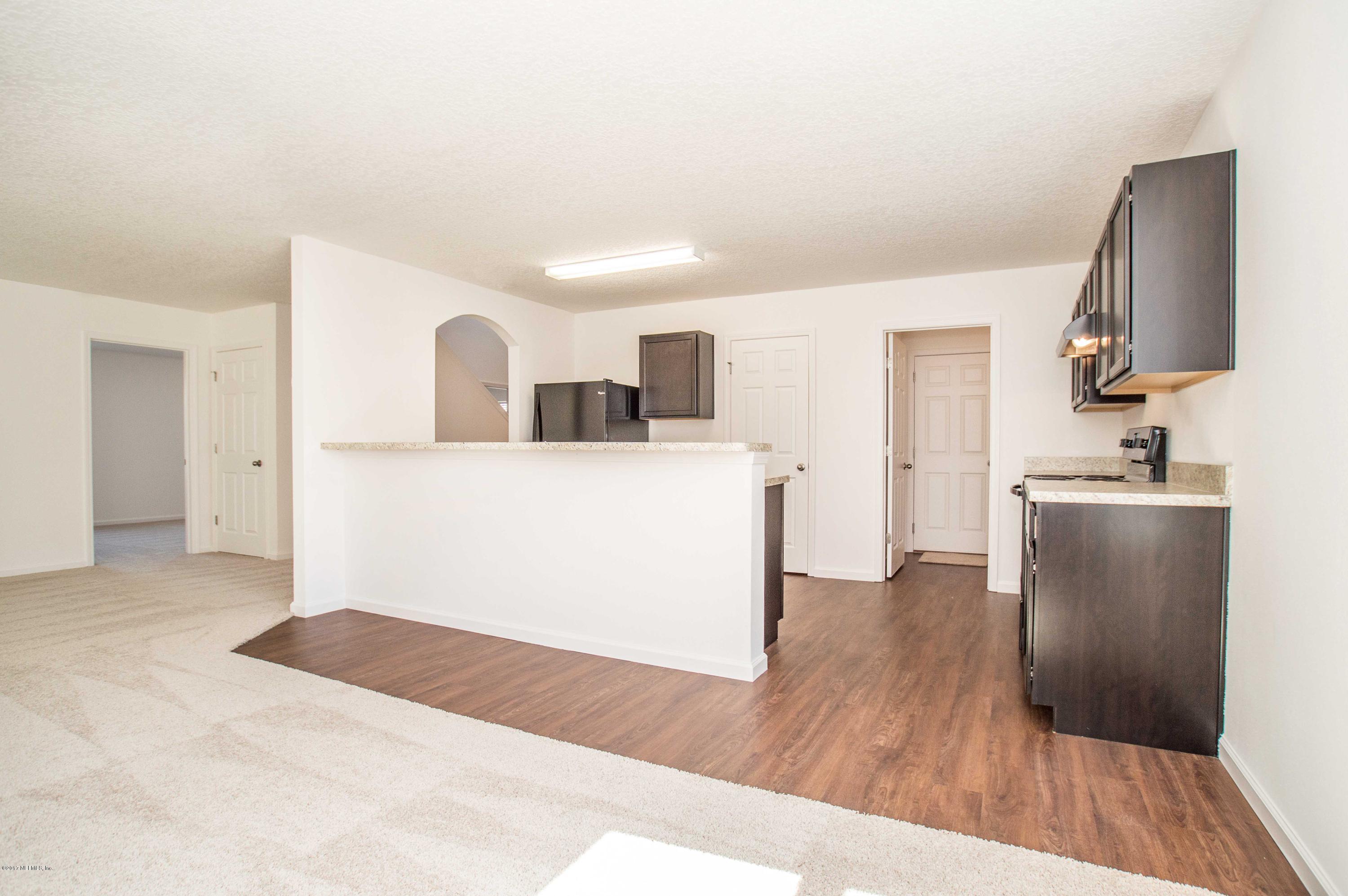 78263 Saddle Rock Road Yulee, FL 32097 - Photo 6 of 13 a kitchen with a refrigerator and a stove top oven