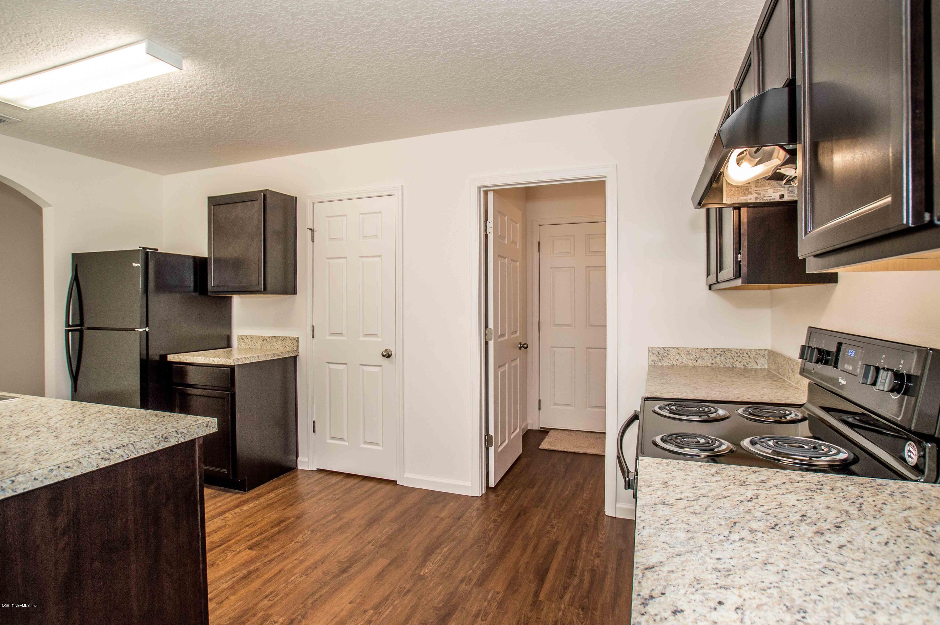 78263 Saddle Rock Road Yulee, FL 32097 - Photo 7 of 13 a kitchen with a refrigerator sink and stove top oven