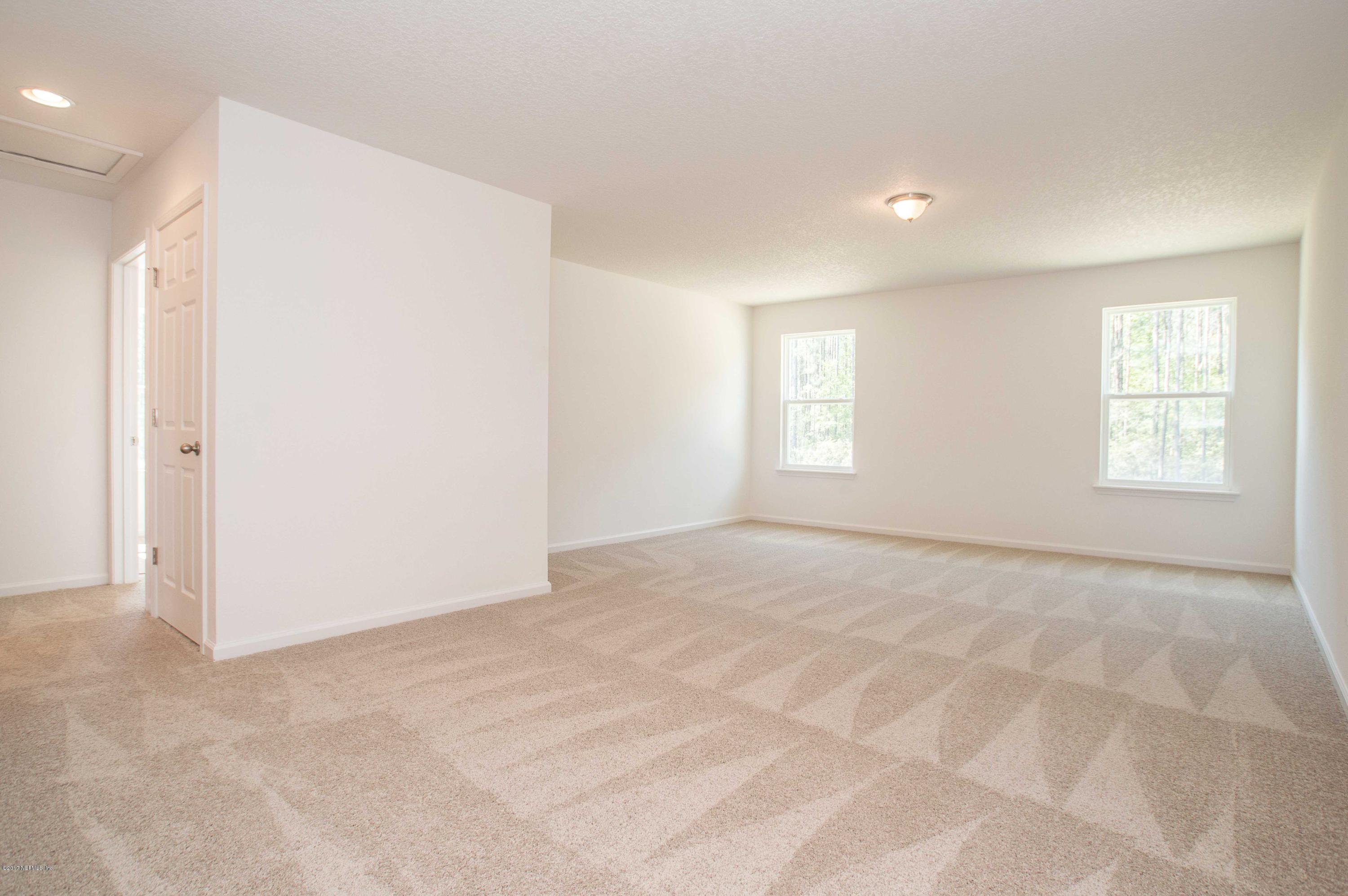 78263 Saddle Rock Road Yulee, FL 32097 - Photo 10 of 13 an empty room with windows