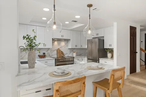 a kitchen with refrigerator and cabinets