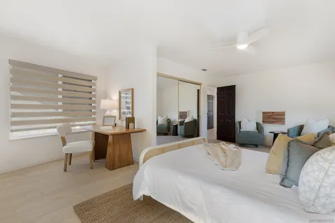 a large bedroom with a bed and window