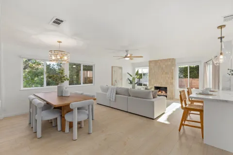 a living room with furniture a chandelier and a table