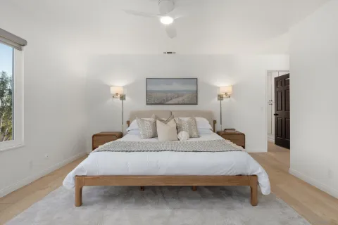 a bedroom with a bed lamp and a window