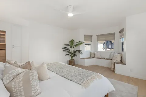 a bedroom with a large bed and a chandelier