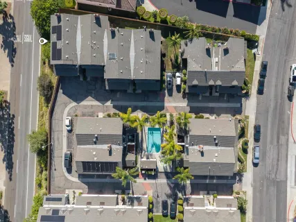 an aerial view of residential houses with outdoor space