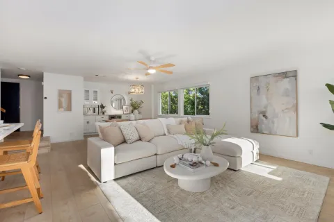 a living room with furniture and a wooden floor