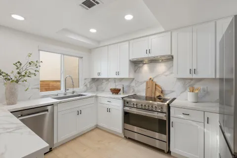 a kitchen that has a sink and a stove