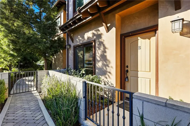 a view of a house with large windows and a small yard