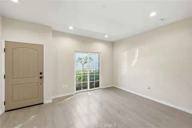 an empty room with windows and closet