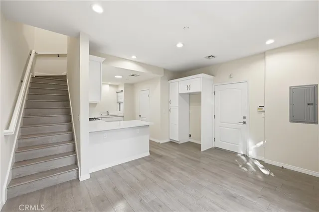 a view of kitchen with sink and refrigerator