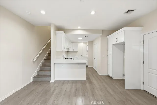 a kitchen with granite countertop white cabinets and white appliances