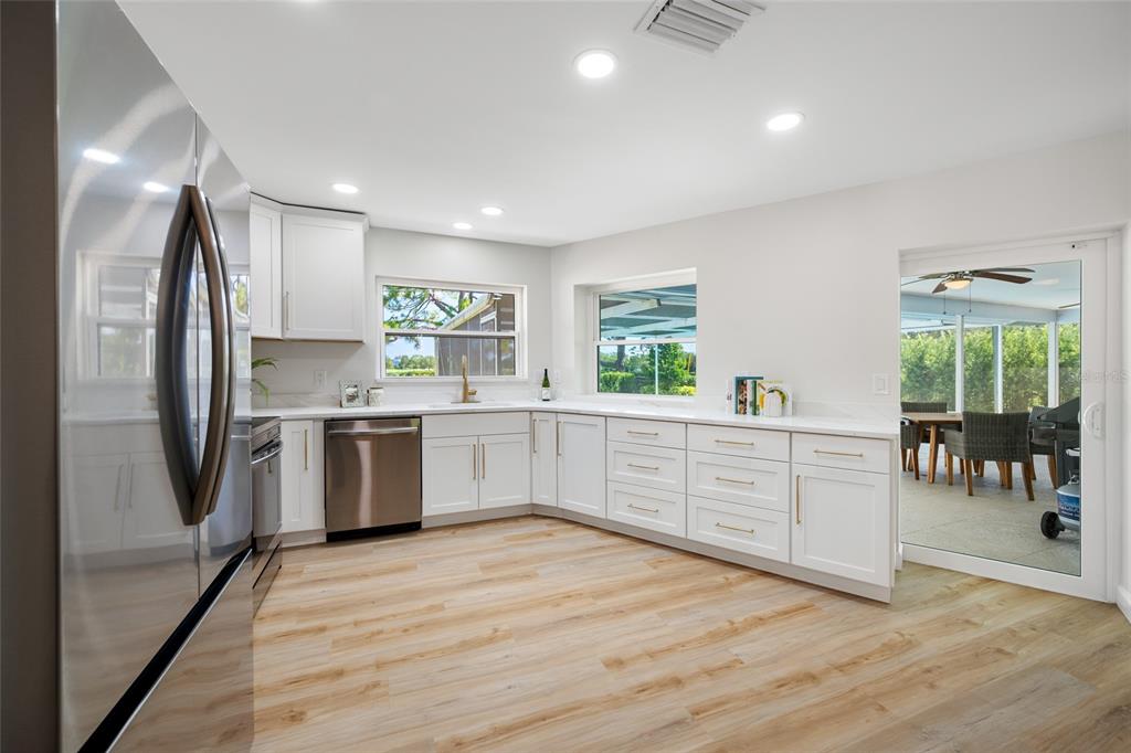 656 Mehlenbacher Road Belleair, FL 33756 - Photo 10 of 49 a kitchen with stainless steel appliances a refrigerator sink and cabinets