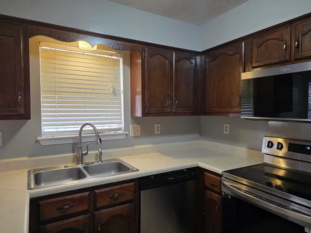 a kitchen with a sink and cabinets
