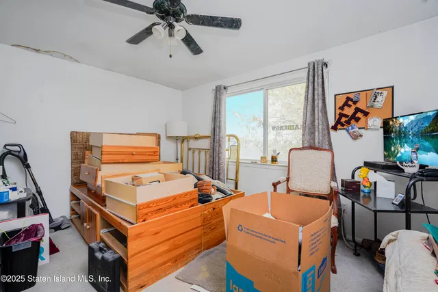 a bedroom with bed and a window