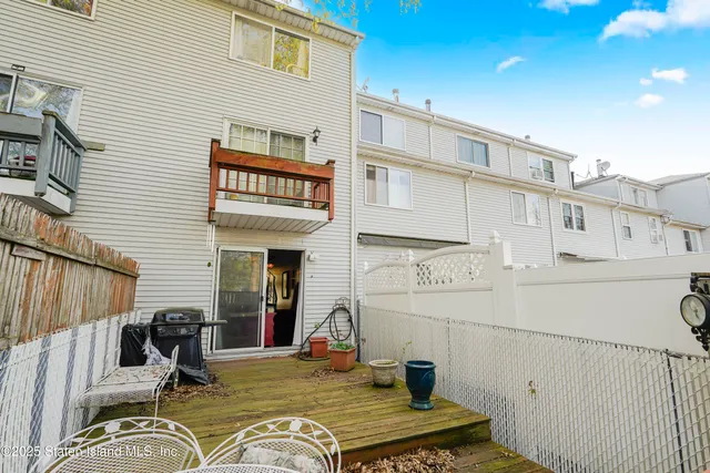 a view of a house with a chairs in patio