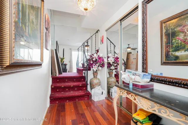 a dining room with wooden floor and large windows