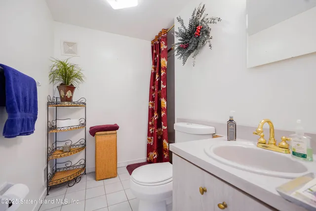 a bathroom with a sink toilet and a mirror