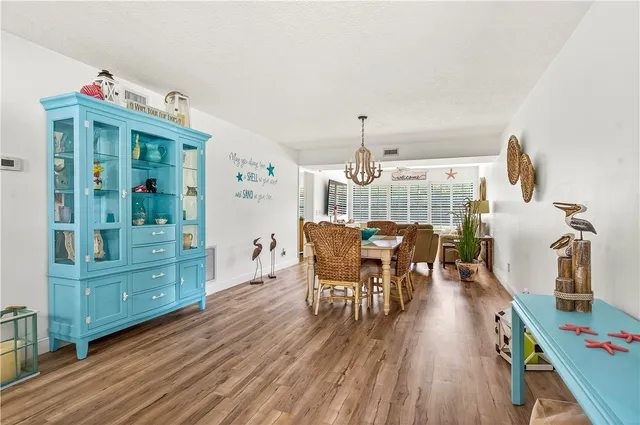 a dining room with furniture and wooden floor