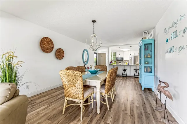 a dining room with furniture and a chandelier