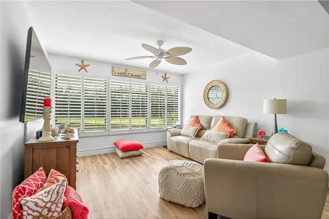 a living room with furniture a bed and a chandelier