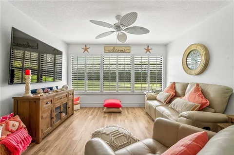 a bedroom with furniture and a large window