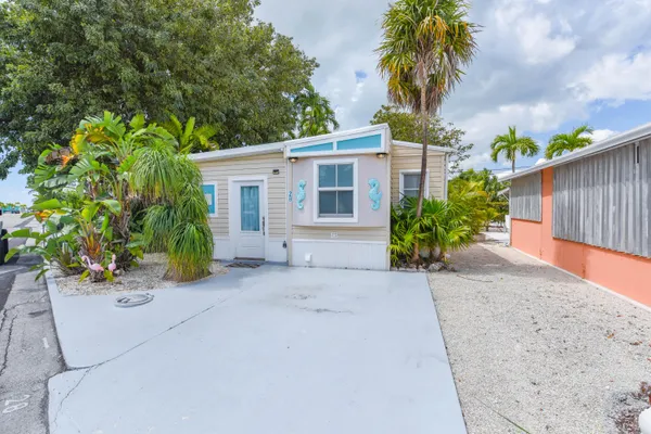 a front view of a house with a yard and a garage
