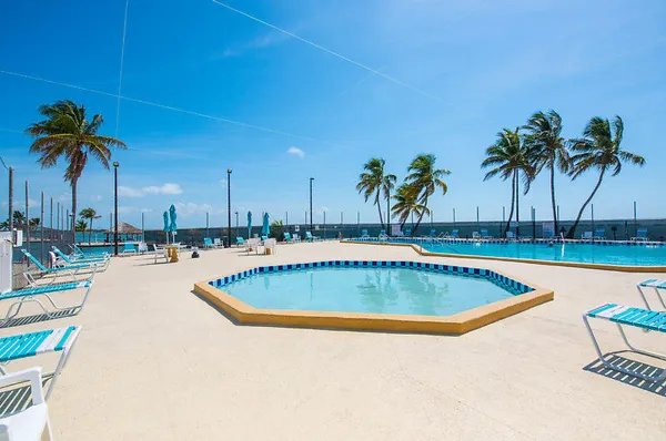 a swimming pool with outdoor seating and yard