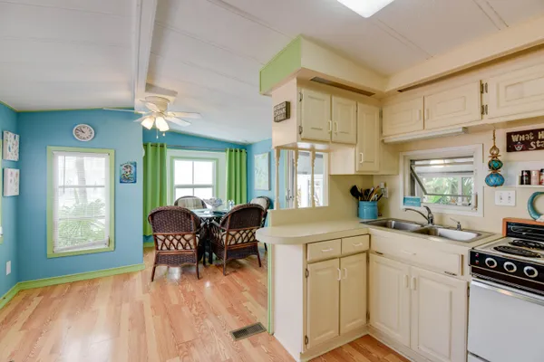 a kitchen that has a cabinets counter space dining table and a window