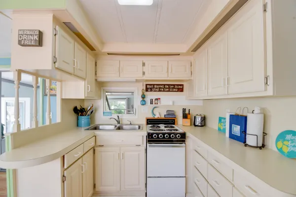 a kitchen with stainless steel appliances kitchen island granite countertop a sink and a cabinets