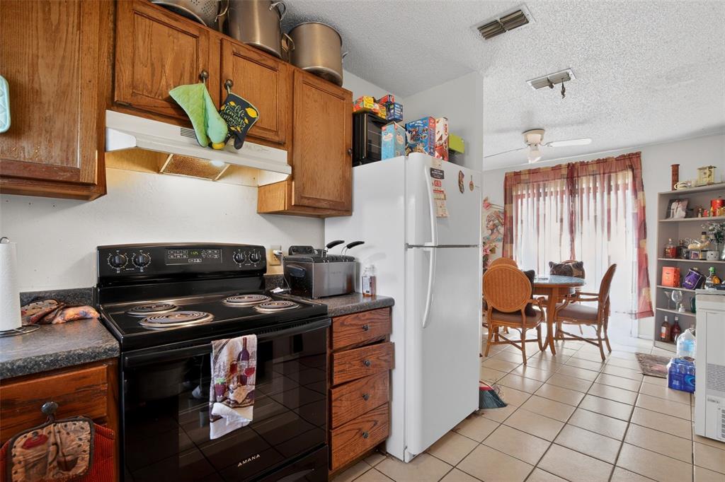 8821 Southeast 89th Place Ocala, FL 34472 - Photo 17 of 30 a kitchen with stainless steel appliances granite countertop a refrigerator and a stove top oven