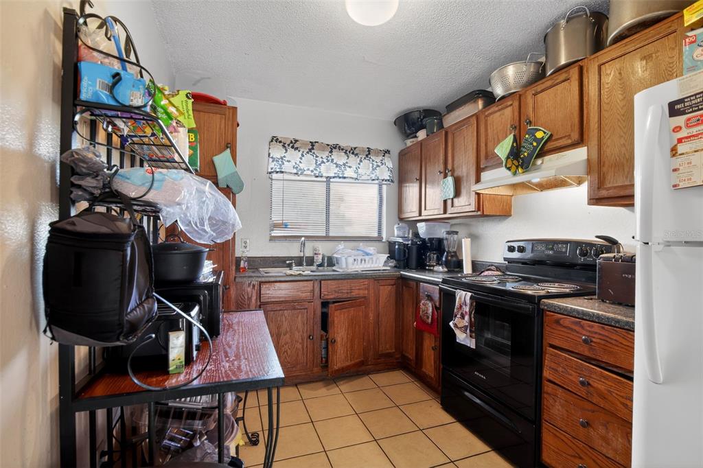 8821 Southeast 89th Place Ocala, FL 34472 - Photo 18 of 30 a kitchen with stainless steel appliances a stove a sink and a refrigerator